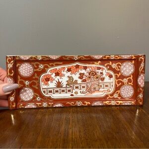 Japanese Imari ware porcelain dish with hand-painted design and gilded accents.